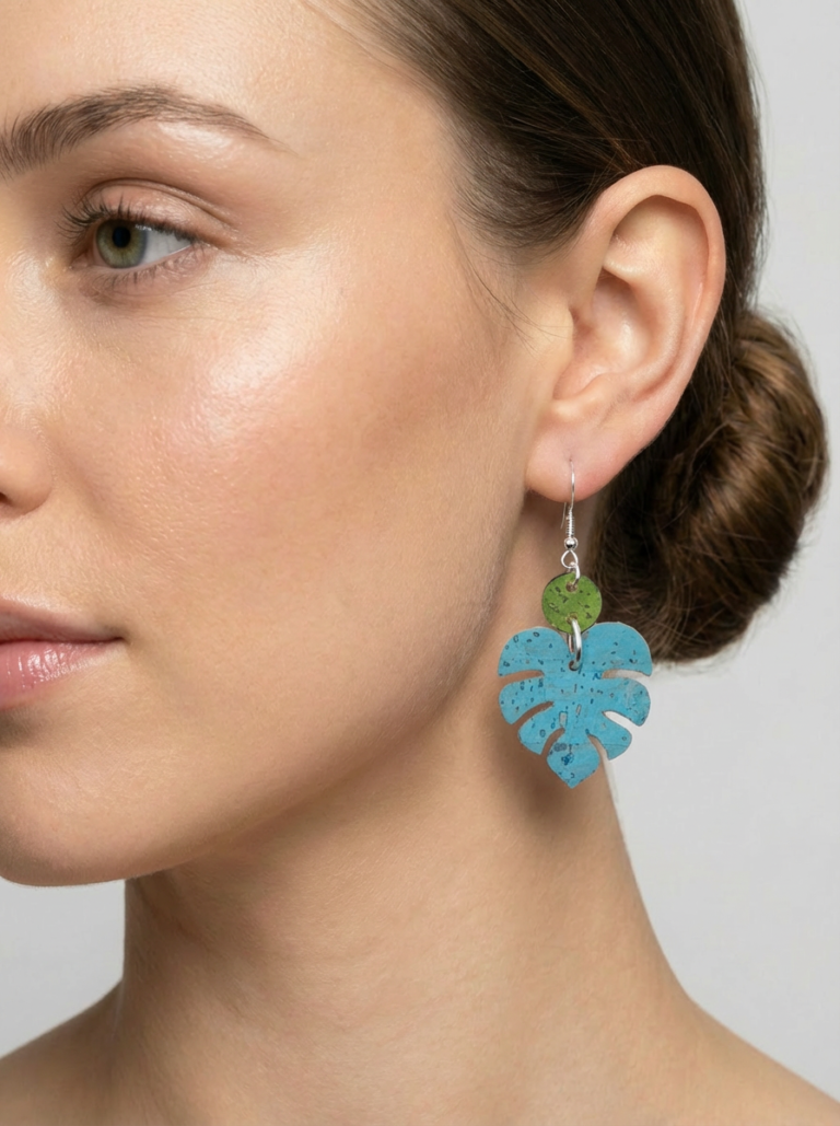 Light Blue monstera dangle earrings on a model