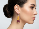 burgundy and yellow dangle cork earrings on model